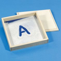 an open box with the letter a on it and a napkin inside that has been folded