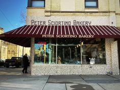 a man walking past a store front on a city street