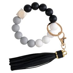 a black and white beaded bracelet with a tassel