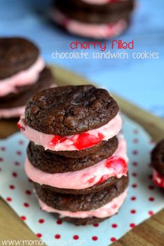 three cookies and ice cream sandwiches on a plate