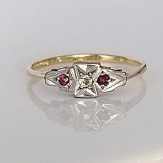 A beautiful understated ruby, diamond and platinum solid gold ring. The lovely rubies are a rich red in colour, complemented by a wonderfully bright old cut diamond which sparkles superbly in natural daylight. Perfect as a gift or for a special special occasion. ▪ Overall Condition: Excellent ▪ Metal: 18ct Gold & Platinum ▪ Gem: Ruby ▪ Gem: Diamond ▪ Gem Cut: Old & Round Cut ▪ Gem Colour: Red & White ▪ Ring Size UK: O.5 ▪ Ring Size US: 7.50 ▪ Marked: Stamped 18ct & Plat ▪ Resizing: Quotation Available ▪ Weight: 1.5gms ▪ Insurance Estimate: £735 ▪ Payment Layaway Plan Available: Yes ▪ Full Detailed Appraisal: Quotation Available As a qualified Gemmologist and Jeweller with over 20 years experience in the jewellery  industry, each jewel is chosen for its  'quality, beauty and interest'... As Antique Ruby Ring With Single Cut Diamonds, Vintage Ruby Rings With Single Cut Diamonds, Antique Ruby Rings With Single Cut Diamonds, Antique Red Diamond Ring With Rose Cut Diamonds, Classic Ruby Ring With Diamond Cut, Classic Ruby Ring In Diamond White, Classic Red Ruby Ring With Single Cut Diamonds, Red Ruby Wedding Rings With Diamond Cut, Heirloom Style Red Ruby Ring With Brilliant Cut