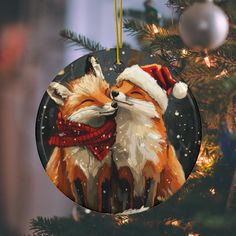 a christmas ornament with a fox wearing a santa hat and scarf on it