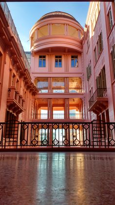 the inside of an apartment building with balconies and railings on either side