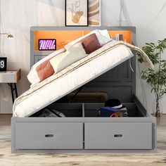 a bed with two drawers underneath it and a mattress in the bottom drawer that is open