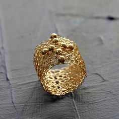 a gold ring sitting on top of a wooden table