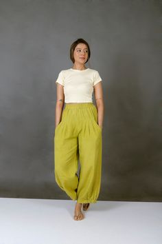 "Unisex Apple Green pants for women, Custom made baggy pant, Bohemian pants, Made to order, Plus size Perfect for summer days.. goes well with cropped top.. Comfy baggy pants.. -Model height: 5'3\" wearing size S -Length: 36\" -Fit: Comfortable -Closure: Elasticated waist Style these linen pants with casual tops or our tank tops. You would want to wear these everyday!" Green Wide Leg Pants For Summer, Green Relaxed Fit Harem Pants With Elastic Waistband, Baggy Tapered Leg Harem Pants For Summer, Relaxed Fit Green Harem Pants, Green Harem Pants With Elastic Waistband, Hippie Pants With Pockets, Bohemian Spring Bottoms With Tapered Leg, Green Ankle-length Harem Pants For Summer, Green Relaxed Fit Parachute Pants For Summer