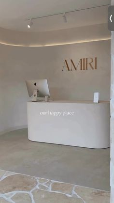 the front desk of an amri store with a laptop on it's desk