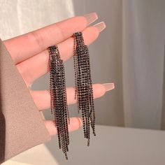 Fashion Element: Tassel Style: Advanced Sense Party Earrings With Alloy Plating, Silver Tassel Single Earring As Gift, Silver Dangle Tassel Earrings For Party, Silver Tassel Dangle Earrings For Party, Silver Tassel Drop Earrings For Evening, Trendy Silver Crystal Earrings For Evening, Trendy Dangle Earrings For Evening, Trendy Silver Jewelry For Evening, Trendy Evening Dangle Earrings