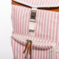 a pink and white striped backpack with brown straps