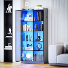 a living room filled with furniture and bookshelves next to a white couch on top of a hard wood floor