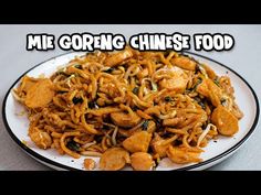 a white plate topped with noodles and meat on top of a gray tablecloth next to a black and white sign that says me going chinese food