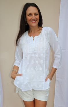 Theigh length tunic /Kurta with full front button opening is one of the gorgeous attire for warm weather. Airy and lightweight companion for a hot summer day. This beautiful Hand embroidered tunic/top is ideal for any functions/party. If you want a classic look then pair it with leggings, skinny jeans, capri. This is a contemporary reflection of traditional Indian Chikan embroidered ethnics which had originated centuries ago in Lucknow. Chikansazi is the exquisite needlework of fine and delicate Traditional Summer Tops With 3/4 Sleeves, Summer Long Sleeve Blouse With Chikankari Embroidery, Summer V-neck Tunic With Chikankari Embroidery, Summer Long Sleeve Chikankari Embroidery Blouse, Summer Long Sleeve Top With Chikankari Embroidery, Summer Long Sleeve Chikankari Embroidered Top, White Tunic With Chikankari Embroidery, Bohemian Tops With Chikankari Embroidery Straight Kurta, Summer V-neck Chikankari Kurta