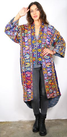 Our “Vintage Mirrored Kimono Coat” is a unique, one of a kind coat. The kimono is made from hand made embroidery mirrored fabric famous from the Rajasthan region of India. One of a kind Vintage (old) embroidered cloth’s are carefully selected by us and mixed and mended and sewn together and stacked in a whimsical hand made way. The Kimono coats are lined with soft hand printed cotton fabric. This unique item is a fabric & fashion lovers dream, and the coat is such a cool Artsy look. The coat is Bohemian Kimono With Multicolor Embroidery For Fall, Multicolor Floral Embroidered Kimono For Fall, Bohemian Embroidered Kimono For Fall, Bohemian Long Kimono With Intricate Embroidery, Multicolor Floral Embroidered Fall Kimono, Floral Embroidered Long Outerwear For Festivals, Fall Multicolor Kimono With Floral Embroidery, Long Outerwear With Intricate Embroidery For Spring, Spring Folk Long Outerwear