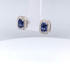 14k White Gold Studded Earrings  Prong Set Blue Sapphire Gemstones- SHAPE: Octagon  SIZE: 6x4mm # OF STONES: 2 WEIGHT: 1.4 carats Diamonds- SHAPE: Round SIZE: 1.3mm (or 1 pt) WEIGHT: 0.36 carats # OF STONES: 36 Gross Gold Weight: 1.83 grams Blue Diamond Gemstone Earrings For Anniversary, Blue Gemstone Diamond Earrings For Anniversary, Elegant Blue Gia Certified Diamond Earrings, Blue Diamond Gemstone Earrings In Fine Jewelry Style, Blue Tanzanite Earrings With Prong Setting, White Gold Sapphire Diamond Earrings, Gia Certified Sapphire Earrings For Formal Occasions, Classic Blue Diamond Earrings, Gia Certified Sapphire Diamond Earrings