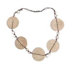 This lightweight statement necklace elegantly combines the luminous beauty of freshwater pearls with the earthy beauty of hand woven rattan. A double strand of waxed cotton knots 12 pearls in place. A piece of organic luxury that will elevate any ensemble. The magnetic closure makes it a snap to put on and remove. The rattan circles are about 1.75". The length of the necklace open is 21". If you would like a shorter version, just leave a note. Add this to your vacation wardrobe today! Elegant Mother Of Pearl Beach Necklace, Elegant Mother Of Pearl Necklace For Beach, Artisan Adjustable Natural Necklace, Artisan Adjustable Natural Necklaces, Artisan Adjustable Natural Color Necklaces, Adjustable Multi-strand Hand Wrapped Necklace, Adjustable Multi-strand Hand Wrapped Necklaces, Handmade Pearl Necklace For Vacation, Handwoven Necklace For Beach