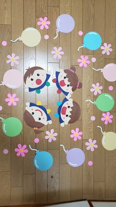 a wooden floor with flowers and balloons on it