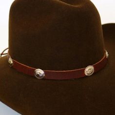 This 1/2 inch thick leather hatband is decorated with oval metal conchos. It is adjustable with a leather string tie.Made in the USASoft Genuine Leather*This product is for 1 single hat band. Hat not included. 100% Leather Austin Accent Hat Band Black Leather Silver Conchos Adjustable Adjustable Wide Brim Felt Hat For Western-themed Events, Adjustable Brimmed Top Hat For Western-themed Events, Adjustable Fedora For Western-themed Events, Adjustable Brown Hat For Rodeo, Western Concho Hat Bands For Rodeo, Western Style Adjustable Flat Brim Hat, Adjustable Brimmed Top Hat For Rodeo, Adjustable Brown Western Jewelry, Adjustable Felt Hat With Curved Brim For Western-themed Events