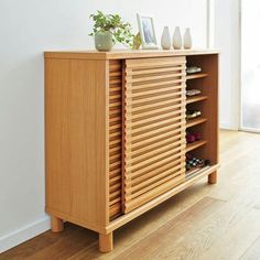 a wooden cabinet with several pairs of shoes sitting on it's top and bottom shelf