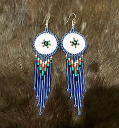 Beautiful Native American Indian Jewelry Navajo Zuni Hand Beaded  Sun Dancer Earrings Great for a gift❤️ Handcrafted by Navajo Artist R. Sellers The Sacred Sun Dance... The Sun Dance is the most sacred ritual of Plains Indians, a ceremony of renewal and cleansing for the tribe and the earth. Primarily male dancers--but on rare occasions women too--perform this ritual of regeneration, healing and self-sacrifice for the good of one's family and tribe. But, in some tribes, such as the Blackfeet, th Southwestern Blue Beaded Fringe Earrings, Blue Southwestern Beaded Fringe Earrings, Southwestern Beaded Round Earrings, Southwestern Style Beaded Round Earrings, Southwestern Round Beaded Earrings, Southwestern Beaded Fringe Earrings For Gift, Southwestern Adjustable Beaded Fringe Earrings, Traditional Beaded Fringe Earrings For Gift, Southwestern Beaded Fringe Dangle Jewelry