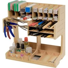 a wooden craft organizer with scissors and other items