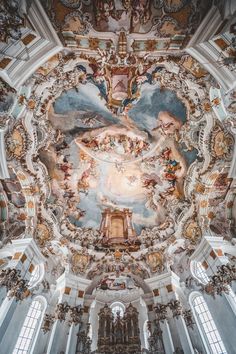 an ornate ceiling in a church with paintings on it