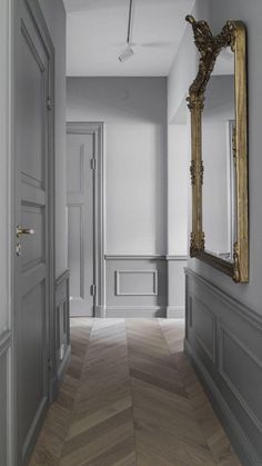 an empty hallway with a mirror on the wall