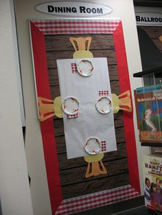 a door decorated to look like a dining room with paper plates on it and an image of a chicken