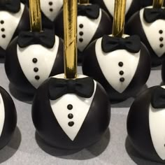 chocolate candies with black and white tuxedos on them are arranged in rows