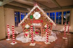 a gingerbread house decorated for christmas with candy canes