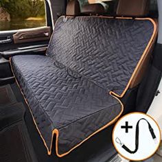 the interior of a car with an orange and black seat cover on it's back