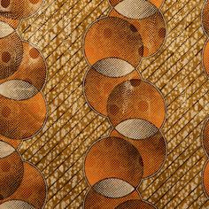 an orange and brown pattern with circles on it's surface, as well as the background