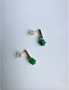 Don't miss this pair of charming little dark green jade stud earrings! Simple and stylish design, hand-made with 18k gold-filled studs and genuine dark green small jade beads, truly a piece of art. No matter it's your day-to-day office wear or adding a bit of classic to the entertaining Friday night, you wouldn't regret wearing these modern-looking and simple green jade hanging earrings. Some highlights of these minimalistic and cute dangle gold jade earrings are: *High-quality materials Hand-ma Minimalist Green Gold-plated Earrings, Minimalist 14k Gold Filled Green Earrings, Jade Earrings, Beads Earrings, Simple Green, Earrings Simple, Hanging Earrings, Jade Jewelry, Jade Beads