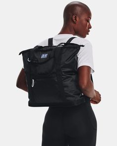 a woman carrying a black backpack in her back