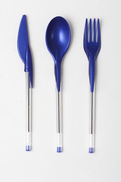 three forks, two spoons and one fork are on a white surface with blue tips