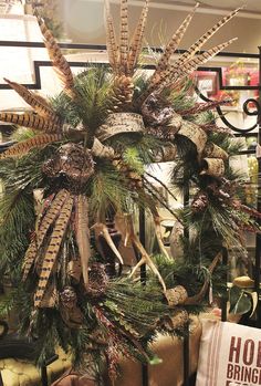 a christmas wreath with pine cones and feathers