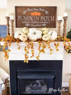 a fireplace mantel decorated with pumpkins and fall leaves, candles and a sign that says pumpkin patch