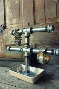 an old fashioned metal faucet on top of a wooden table in front of a door