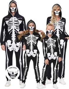 the family is wearing skeleton costumes for halloween