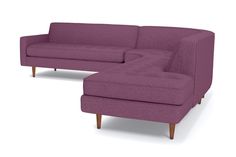 a purple couch and footstool sitting next to each other on a white background