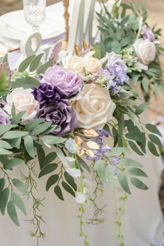 the table is decorated with flowers and greenery