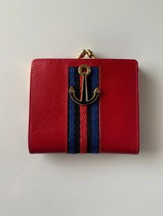 Vintage red leather wallet with blue suede lining from Saks Fifth Avenue.  Made in Italy. Excellent vintage condition.  Never been used. Anchor hardware with brass coin clasp.  Size: 3x3.5 Wallet open: 3x6.5 Red Vintage Leather Wallets, Red Vintage Bifold Wallet, Vintage Red Bifold Wallet, Compact Red Leather Wallet, Compact Red Wallet For Daily Use, Red Leather Bifold Coin Purse, Vintage Red Coin Purse For Daily Use, Red Wallet, Coin Wallet