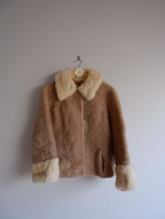 Beautiful vintage Australian lamb wool coat, fully lined. Features pockets and hook closure. See video for ultimate collar softness!  ~ ❊ ~ D E T A I L S Best fits: S / M Condition: Great Vintage Label: - Material: Genuine Australian Lamb Wool & Fur Collar  M E A S U R E M E N T S Pit to pit: 23" Shoulder to shoulder: 20" Length: 24" Sleeve Length: 21" ~ ❊ ~ Please keep in mind that all vintage items are pre-loved and pre-owned. Some pieces may show natural wear and minor imperfections -only add Vintage Cream Fur Coat For Winter, Cream Vintage Fur Coat For Winter, Vintage Beige Long Sleeve Fur Coat, Vintage Beige Fur Coat, Vintage Lined Winter Outerwear, Vintage Lined Outerwear For Winter, Vintage Labels, Fur Collar, Fur Collars