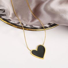 Embrace your bold and stylish side with our Black Heart Pendant Waterproof Stainless Steel Necklace. This necklace features a unique black peach heart pendant, crafted from durable stainless steel. Make a statement and add a touch of elegance to any outfit with this must-have accessory. Minimalist Black Heart Charm Necklace, Minimalist Black Heart Necklace, Elegant Black Open Heart Necklace, Black Metal Heart Necklace With Charm, Black Metal Necklace With Heart Charm, Black Metal Heart Necklace With Heart Charm, Trendy Black Metal Heart Necklace, Black Metal Heart Charm Necklace, Trendy Black Heart-shaped Necklace