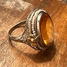 10kt White Gold Filigree Ring With A Large Oval Faceted Citrine In The Center, Bezel Set. It Is Surrounded By Seed Pearls That Are Secured By Beautiful 14kt Yellow Gold Flowers. The Mounting Has Delicate Filigree Work And Engraving. Circa 1925. Pearls Were Secured When I Purchased It. Ring Is Around A 7.25. Can Be Resized. Ring With Pearls, Filigree Ring Gold, Jewelry Antique, Citrine Ring, Gold Filigree, Filigree Ring, Seed Pearl, Pearl Color, Gold Flowers