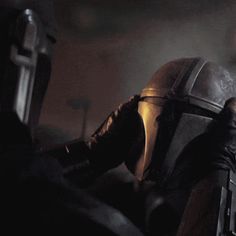 a man in a star wars helmet with his hands on his face