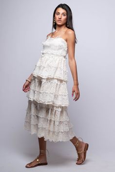 The Rumi Midi Dress is a simple yet elegant choice for any occasion. With its off-white color, tiered design, and lace detailing, this strapless bustier midi dress is sure to make you feel confident and stylish. Hand Wash 100% Cotton Import Fit Guide: Libby is 5ft 9 inches; Bust 34”, Waist 25”, Hips 34” Model is wearing a small True to size *Available at our Envy location Tiered Midi Dress With Lace Trim For Garden Party, Strapless Ruffled Midi Dress For Garden Party, Elegant Tiered Lace Midi Dress, Tiered Midi Dress With Lace Trim For Party, Lace Midi Dress With Ruffles, White Lace Midi Dress With Spaghetti Straps, White Tiered Lace Dress For Summer, Feminine Tiered Midi Dress With Lace Trim, White Midi Tiered Dress For Garden Party