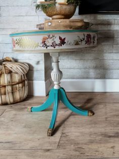 a blue and white table sitting on top of a wooden floor