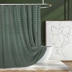 a green shower curtain next to a white sink