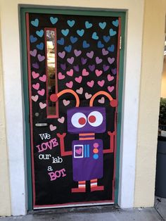 a door decorated with hearts and an image of a robot holding a heart on it