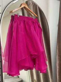 A flowing flared silk skirt cut out of layers of organza, the Freesia Skirt is an image of grace and romance. Wear with your favorite tee or the matching Lin Organza Tee. Elastic silk waistband, delicately lined with silk habotai for coverage. Available in fuchsia. 100% silk organza, silk habotai. Made in New York's Garment District by a small team of dedicated seamstresses. Ships in 10 business days. Pink Tiered Skirt For Evening, Pink Tiered Evening Skirt, Pink Silk Full Skirt, Flowy Party Skirt With Ruffles, Flowy Ruffled Skirt For Cocktail Occasions, Evening Ruffled Organza Skirt, Evening Organza Ruffled Skirt, Flowy Draped Skirt With Ruffles For Party, Flowy Pleated Party Skirt